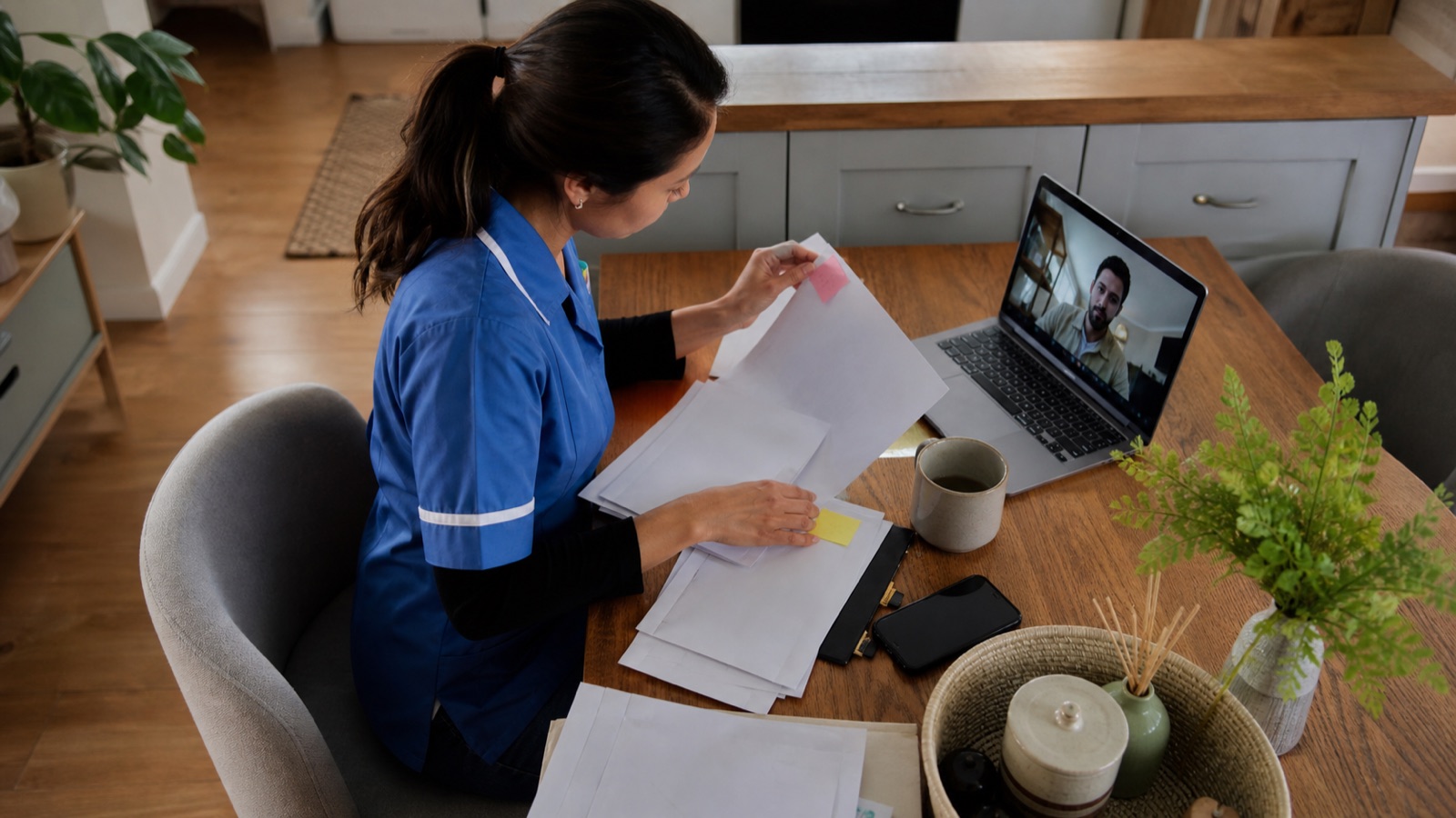 Care worker reviewing family visa dates at a kitchen table